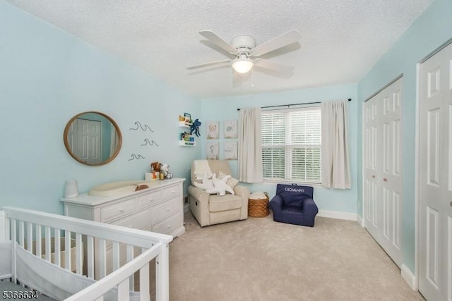 204 Robertson Way Unit 204, Lincoln Park Boro, NJ 07035 - bedroom with light colored carpet, a nursery area, a textured ceiling, and a ceiling fan