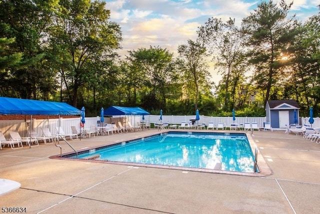 204 Robertson Way Unit 204, Lincoln Park Boro, NJ 07035 - community pool with a patio area, a fenced backyard, a storage unit, and view of wooded area
