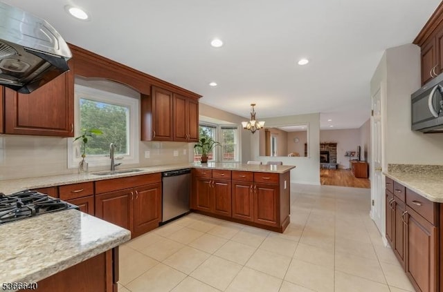 836 Dow Rd, Bridgewater Twp, NJ 08807 - kitchen with appliances with stainless steel finishes, exhaust hood, a peninsula, a chandelier, and plenty of natural light