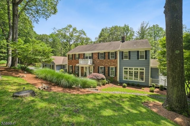 22 Saddle Hill Rd, Mendham Twp, NJ 07931 - rear view of house with a yard, brick siding, a balcony, and a chimney