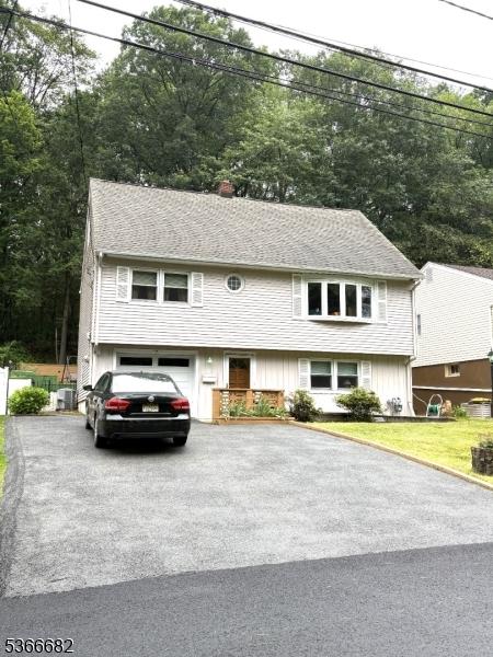 158 Woodhaven Dr, Wayne Twp, NJ 07470 - view of front of property with driveway, a garage, a chimney, and a front lawn