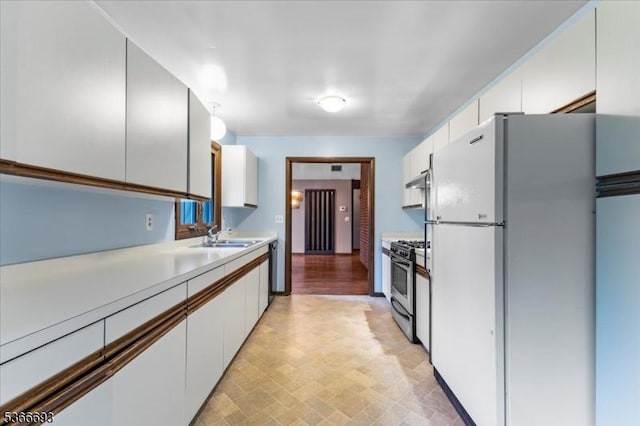 31 Casper Berger Rd, Readington Twp, NJ 08889 - kitchen with freestanding refrigerator, stainless steel gas stove, light countertops, white cabinets, and under cabinet range hood