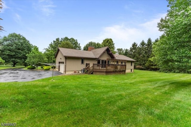 31 Casper Berger Rd, Readington Twp, NJ 08889 - back of property with a deck, a lawn, a chimney, view of scattered trees, and a garage
