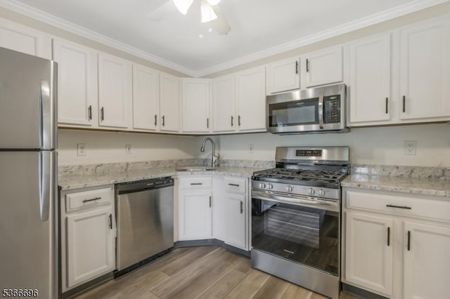 2909 Lindsley Rd, Bridgewater Twp, NJ 08807 - kitchen featuring appliances with stainless steel finishes, a ceiling fan, light stone counters, light wood finished floors, and crown molding