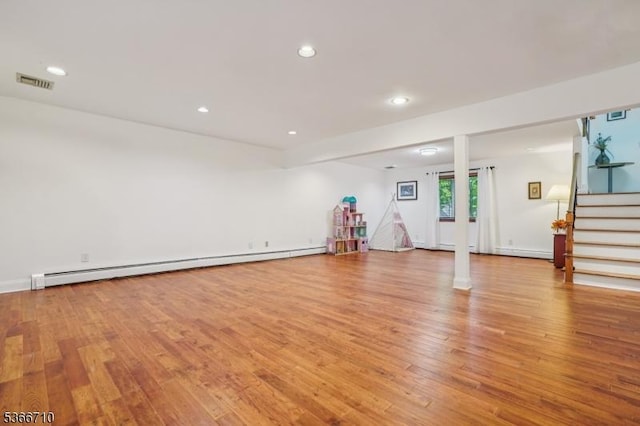 15 Woglum Pl, Berkeley Heights Twp, NJ 07922 - unfurnished living room featuring baseboard heating, stairs, light wood-type flooring, and recessed lighting