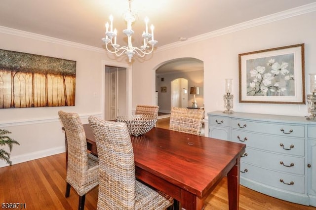 107 Oak Ln, Cranford Twp, NJ 07016 - dining room with arched walkways, a chandelier, light wood-type flooring, and ornamental molding
