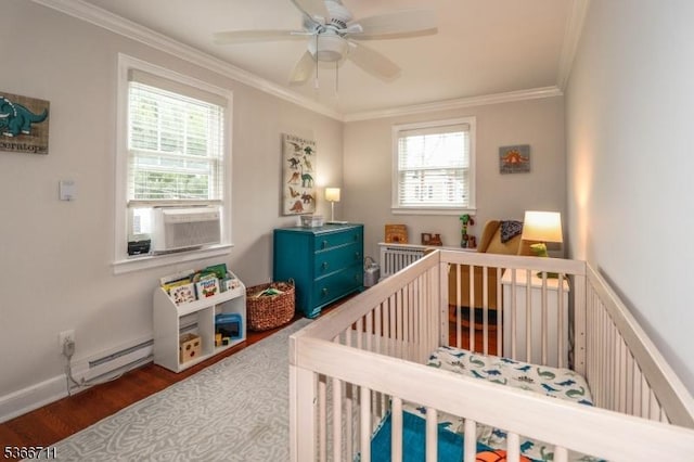 107 Oak Ln, Cranford Twp, NJ 07016 - bedroom with a crib, crown molding, wood finished floors, baseboard heating, and ceiling fan