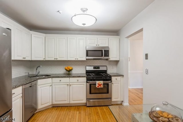 227 Potomac Dr, Bernards Twp, NJ 07920 - kitchen featuring appliances with stainless steel finishes, white cabinetry, backsplash, and light wood-style floors