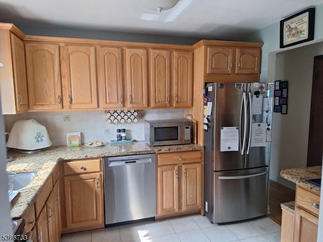 21 Fagan Pl, Woodbridge Twp, NJ 07067 - kitchen featuring stainless steel appliances, light stone countertops, tasteful backsplash, and light tile patterned floors