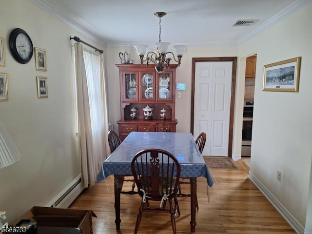 21 Fagan Pl, Woodbridge Twp, NJ 07067 - dining room with baseboard heating, a chandelier, light wood-style flooring, and ornamental molding