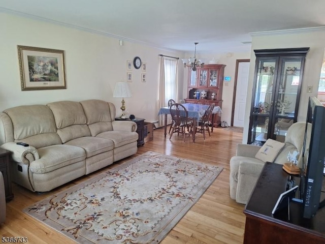 21 Fagan Pl, Woodbridge Twp, NJ 07067 - living room featuring a chandelier, ornamental molding, plenty of natural light, and light wood-type flooring