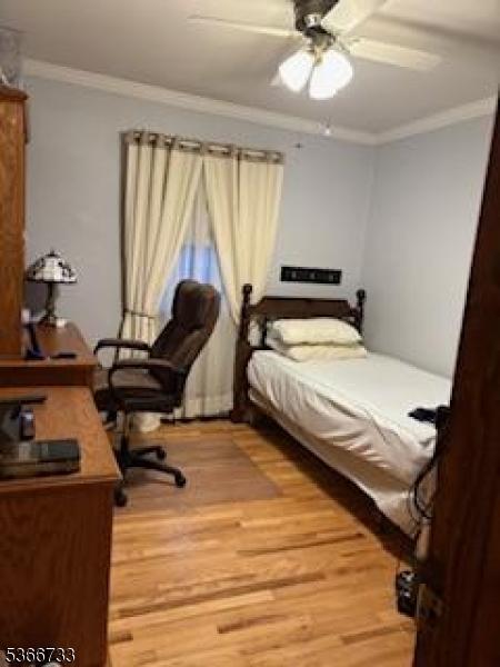21 Fagan Pl, Woodbridge Twp, NJ 07067 - bedroom featuring crown molding, light wood-style floors, a ceiling fan, and an office area