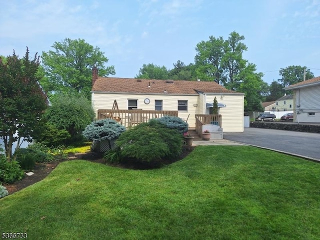 21 Fagan Pl, Woodbridge Twp, NJ 07067 - back of house with a chimney, a yard, and a deck