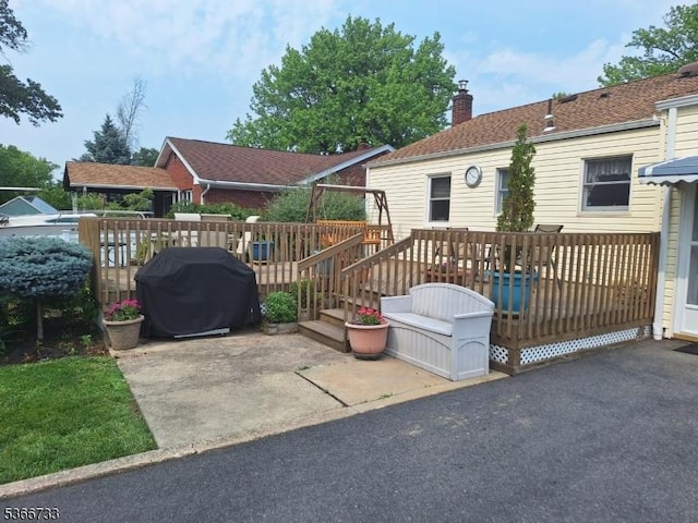 21 Fagan Pl, Woodbridge Twp, NJ 07067 - view of front of house with a chimney, a deck, and a patio