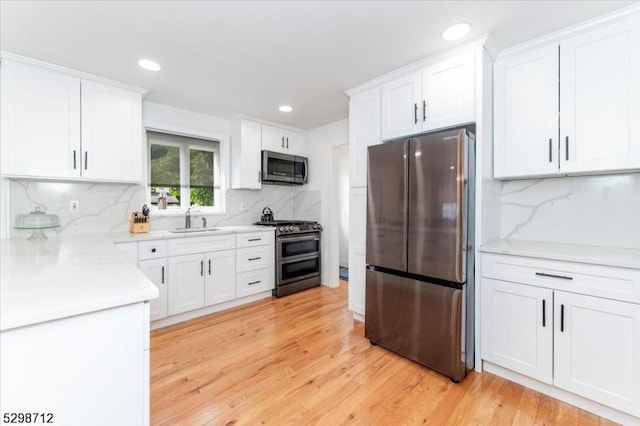 608 Duquesne Ter, Union Twp, NJ 07083 - kitchen featuring stainless steel appliances, tasteful backsplash, white cabinets, light countertops, and recessed lighting