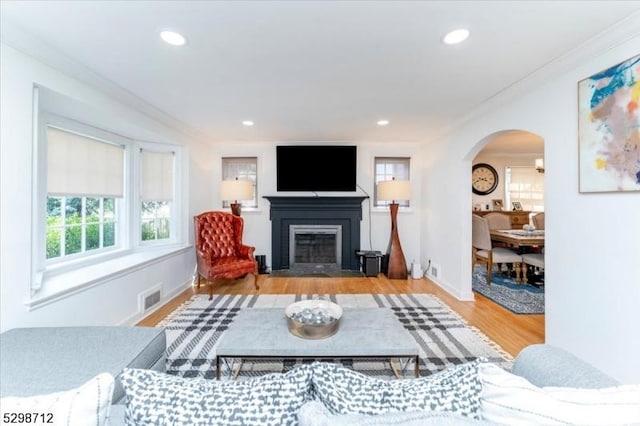 608 Duquesne Ter, Union Twp, NJ 07083 - living room featuring arched walkways, a fireplace with flush hearth, wood finished floors, crown molding, and recessed lighting