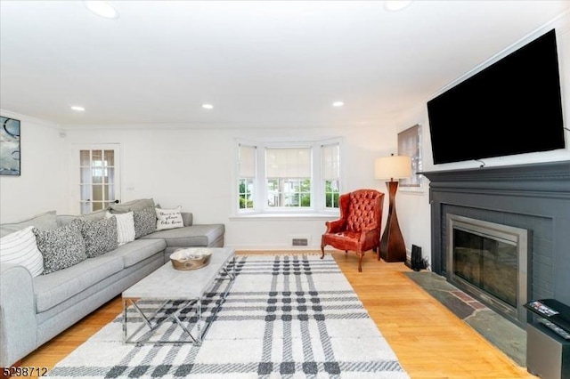 608 Duquesne Ter, Union Twp, NJ 07083 - living area with a fireplace with flush hearth, wood finished floors, recessed lighting, and crown molding