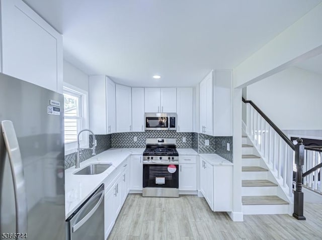 44 Sullivan Way E, Brunswick Twp, NJ 08816 - kitchen with appliances with stainless steel finishes, light stone countertops, light wood-style floors, white cabinetry, and recessed lighting