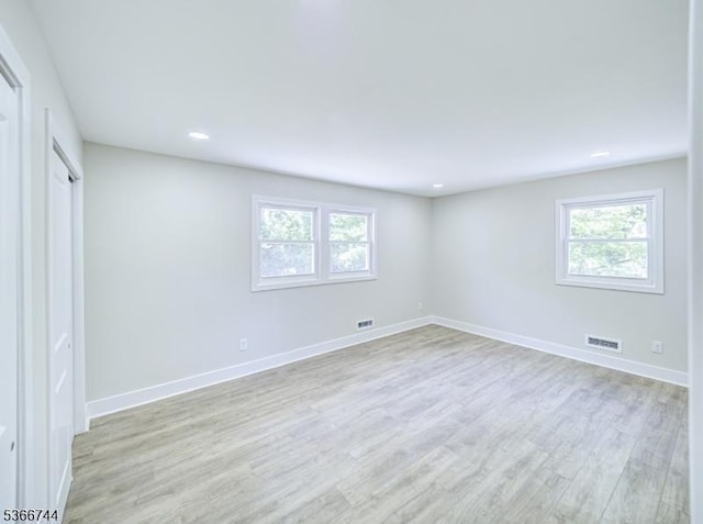 44 Sullivan Way E, Brunswick Twp, NJ 08816 - unfurnished bedroom featuring light wood finished floors, multiple windows, and recessed lighting