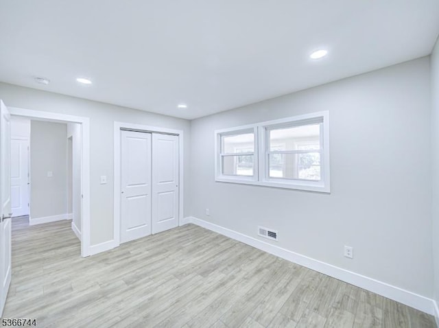 44 Sullivan Way E, Brunswick Twp, NJ 08816 - unfurnished bedroom with light wood finished floors, a closet, and recessed lighting