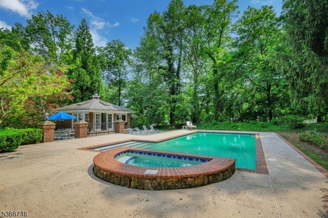 6 Magnolia Ct, Morris Twp, NJ 07960 - view of pool with a patio, an outbuilding, a pool with connected hot tub, and view of wooded area