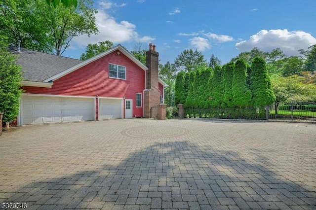 6 Magnolia Ct, Morris Twp, NJ 07960 - view of home's exterior featuring decorative driveway and a chimney