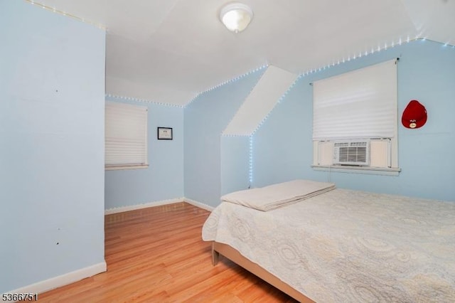 139 Churchill Ave, Franklin Twp, NJ 08873 - bedroom with lofted ceiling, cooling unit, and wood finished floors