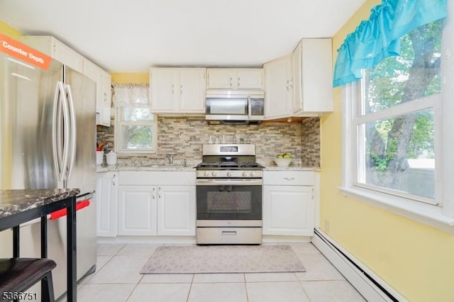 139 Churchill Ave, Franklin Twp, NJ 08873 - kitchen with appliances with stainless steel finishes, a baseboard radiator, tasteful backsplash, white cabinets, and light tile patterned floors