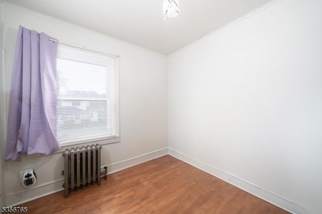 129 Ball St, Irvington Twp, NJ 07111 - spare room featuring radiator, ornamental molding, and wood finished floors
