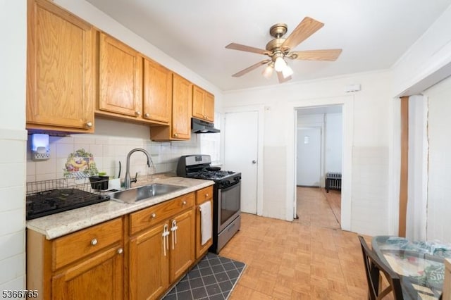 129 Ball St, Irvington Twp, NJ 07111 - kitchen featuring stainless steel gas stove, under cabinet range hood, light countertops, ceiling fan, and decorative backsplash