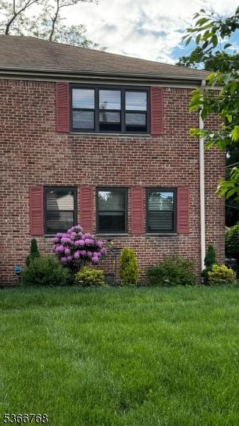 53 Sandra Cir Unit 4, Westfield Town, NJ 07090 - rear view of property with brick siding and a lawn