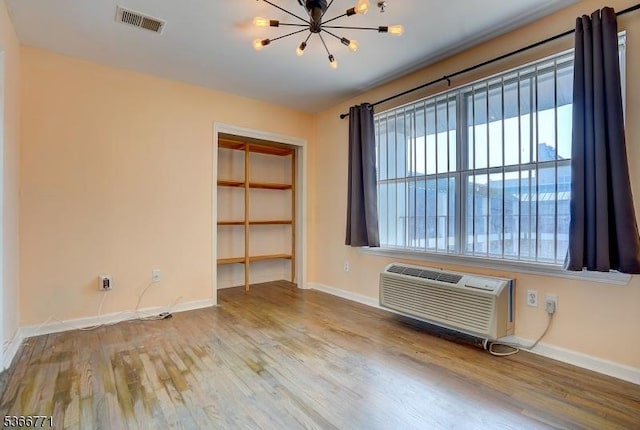 54 Polk Unit P3, Newark City, NJ 07105 - spare room featuring a chandelier, wood finished floors, and a wall mounted AC