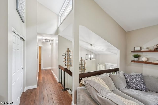 159 Kings Hwy, Washington Twp, NJ 07853 - corridor featuring wood-type flooring, a chandelier, radiator, an upstairs landing, and high vaulted ceiling