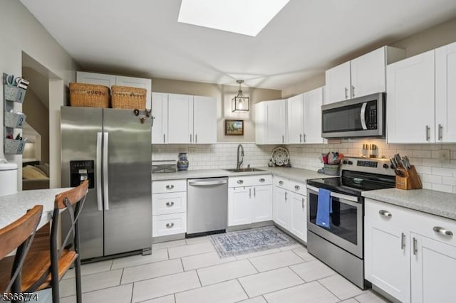 159 Kings Hwy, Washington Twp, NJ 07853 - kitchen featuring appliances with stainless steel finishes, decorative backsplash, and light countertops