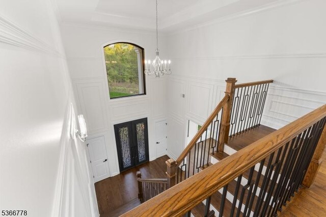 150 Parsippany Blvd, Parsippany-Troy Hills Twp, NJ 07005 - entryway featuring a chandelier, wood finished floors, stairway, and crown molding