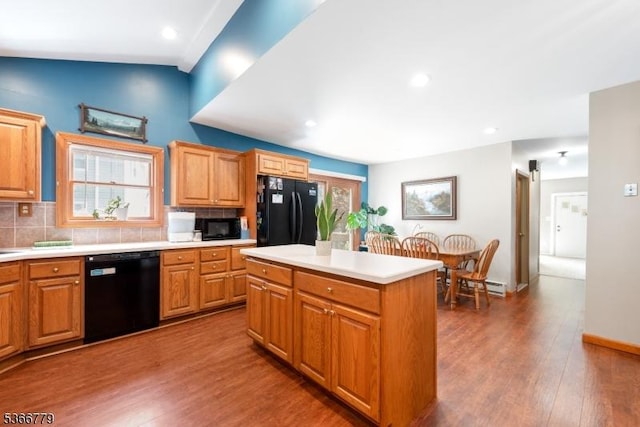 25 Alabama Ave, Jefferson Twp, NJ 07849 - kitchen with black appliances, wood finished floors, light countertops, backsplash, and a kitchen island