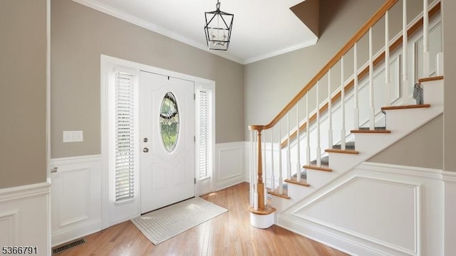31 Burniston Ct, Hillsborough Twp, NJ 08844 - foyer entrance with a decorative wall, a wainscoted wall, stairs, wood finished floors, and plenty of natural light