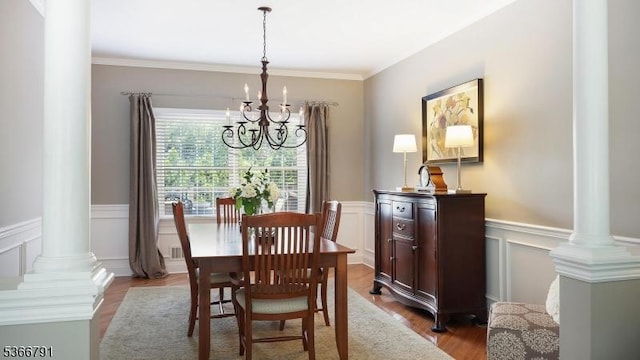 31 Burniston Ct, Hillsborough Twp, NJ 08844 - dining space with a chandelier, decorative columns, wood finished floors, wainscoting, and a decorative wall