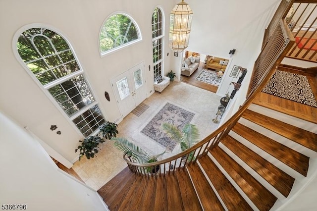 17 N Ridge Rd, Denville Twp, NJ 07834 - foyer with a towering ceiling, stairs, a chandelier, french doors, and wood finished floors