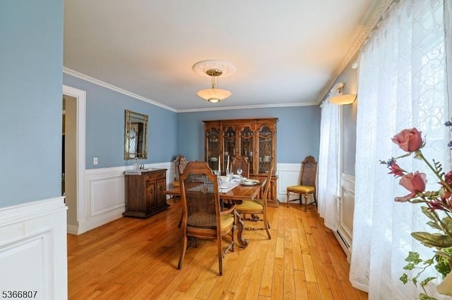 4 Panorama Dr, Vernon Twp, NJ 07461 - dining room with light wood-style floors, a wainscoted wall, crown molding, a baseboard heating unit, and a decorative wall