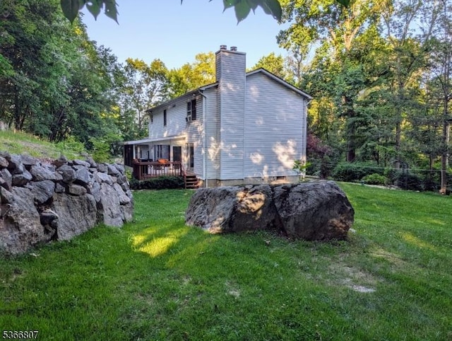4 Panorama Dr, Vernon Twp, NJ 07461 - back of house featuring a chimney, a wooden deck, and a yard