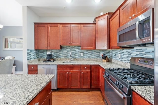 6 Elston Ct, Wanaque Boro, NJ 07420 - kitchen featuring appliances with stainless steel finishes, light wood-type flooring, tasteful backsplash, light stone countertops, and recessed lighting