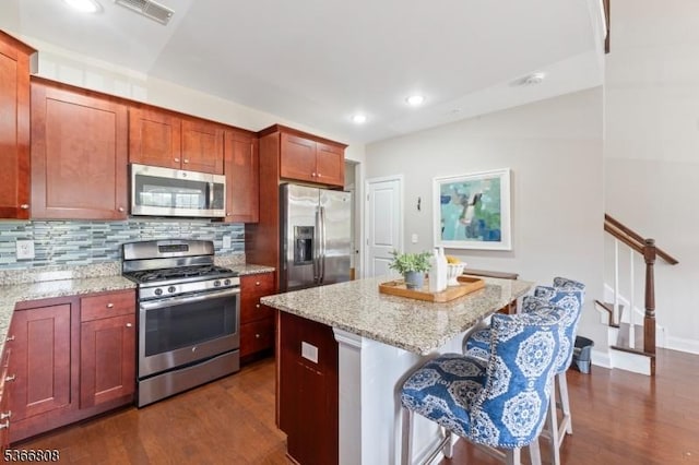 6 Elston Ct, Wanaque Boro, NJ 07420 - kitchen featuring stainless steel appliances, a kitchen island, dark wood-type flooring, backsplash, and light stone countertops