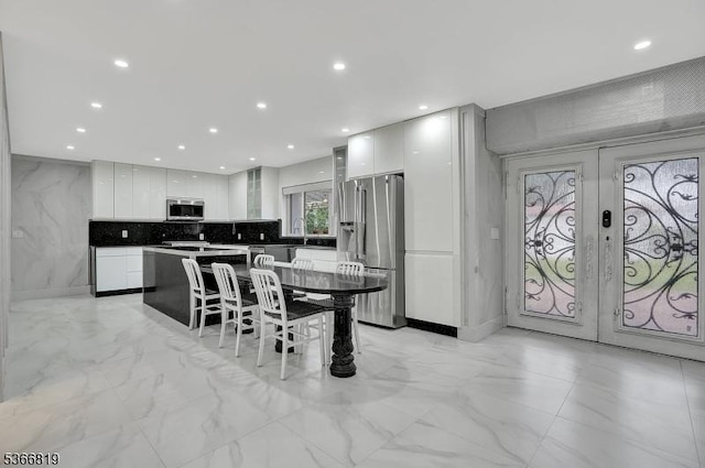 85 Francisco Ave, Little Falls Twp, NJ 07424 - dining area with light marble finish floors, french doors, and recessed lighting