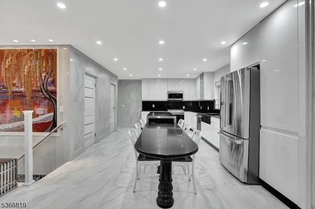 85 Francisco Ave, Little Falls Twp, NJ 07424 - kitchen with modern cabinets, stainless steel appliances, white cabinetry, light marble finish floors, and recessed lighting