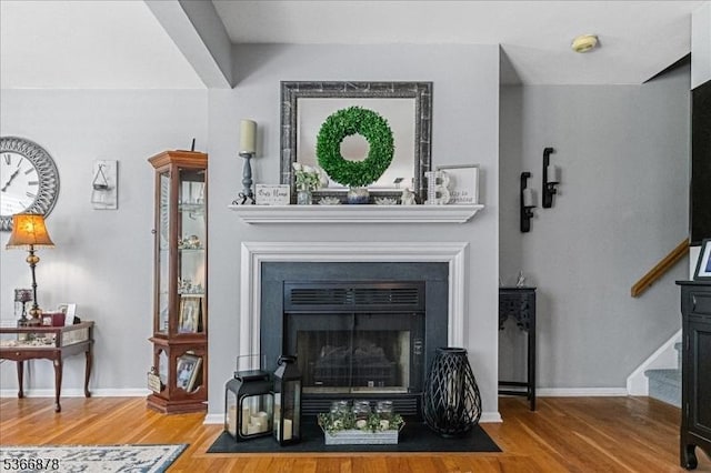 40 Lancelot Dr, Berkeley Heights Twp, NJ 07922 - living room featuring wood finished floors, stairway, and a fireplace with flush hearth