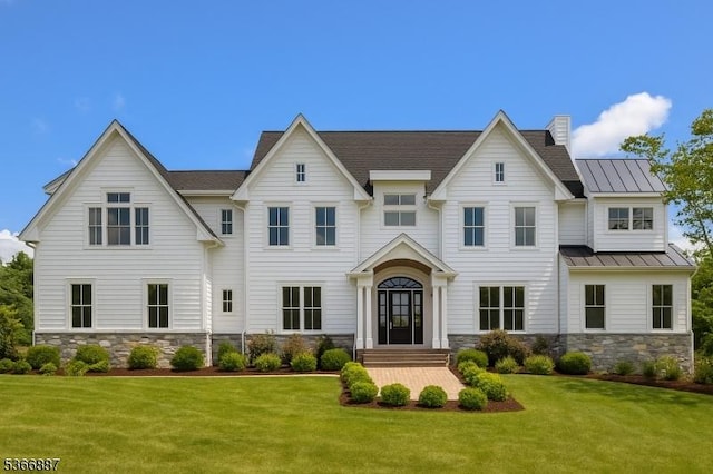 520 Clinton Ave, Wyckoff Twp, NJ 07481 - view of front of home featuring a front yard, a standing seam roof, stone siding, and a metal roof