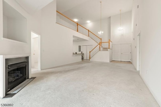7303 Ravenscroft Rd Unit 7303, Clifton City, NJ 07013 - unfurnished living room with a high ceiling, carpet, a chandelier, and a fireplace with flush hearth