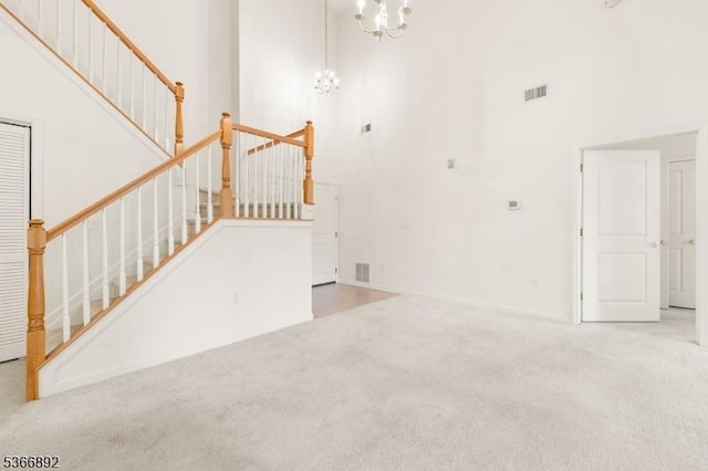 7303 Ravenscroft Rd Unit 7303, Clifton City, NJ 07013 - unfurnished living room featuring a high ceiling, carpet, a chandelier, and stairway