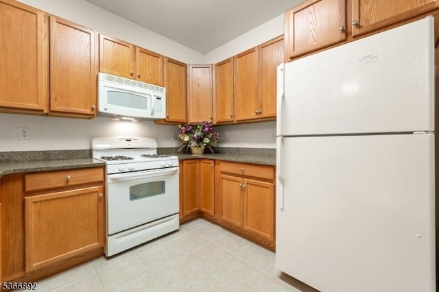 7303 Ravenscroft Rd Unit 7303, Clifton City, NJ 07013 - kitchen featuring white appliances, dark countertops, and brown cabinetry